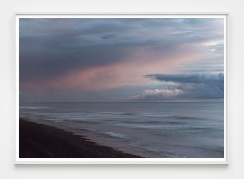 dramatic cloud cover over ocean photograph