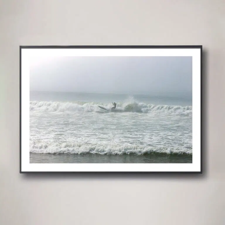 surfer in fog with dramatic lighting photograph
