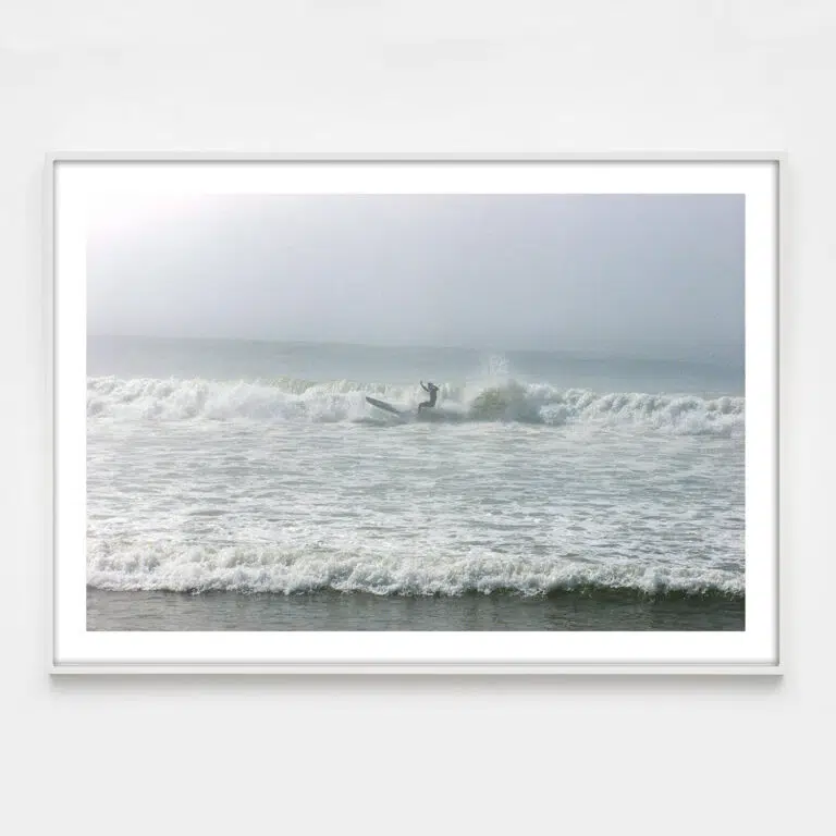 surfer in fog with dramatic lighting photograph